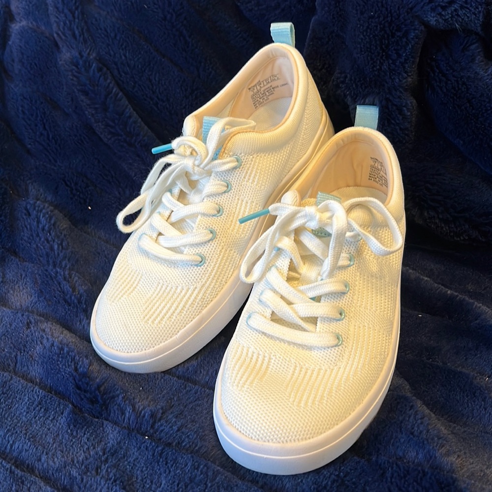 NURTURE//RESTORE. WHITE SNEAKERS. LITE BLUE EYELETS. TIE UPS. COMFORT BRAND